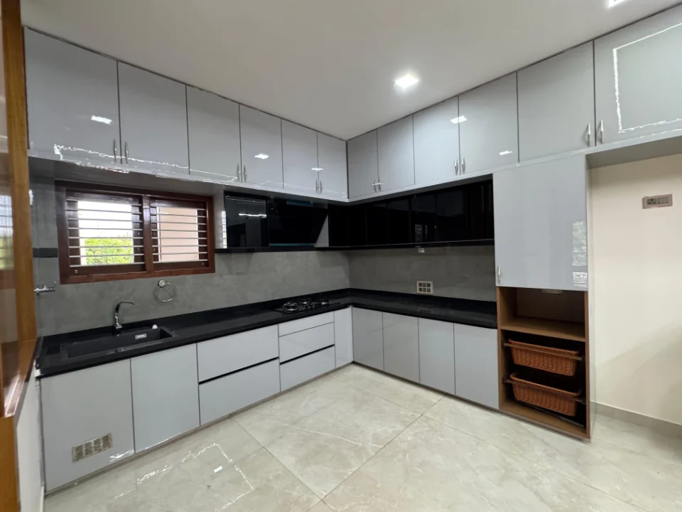 Completed L-shaped kitchen with wood-tone cabinets and dark countertop