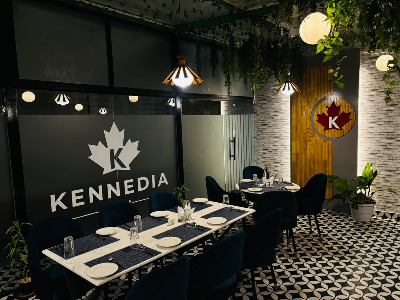 Kennedia Blu dining area with feature wall and greenery