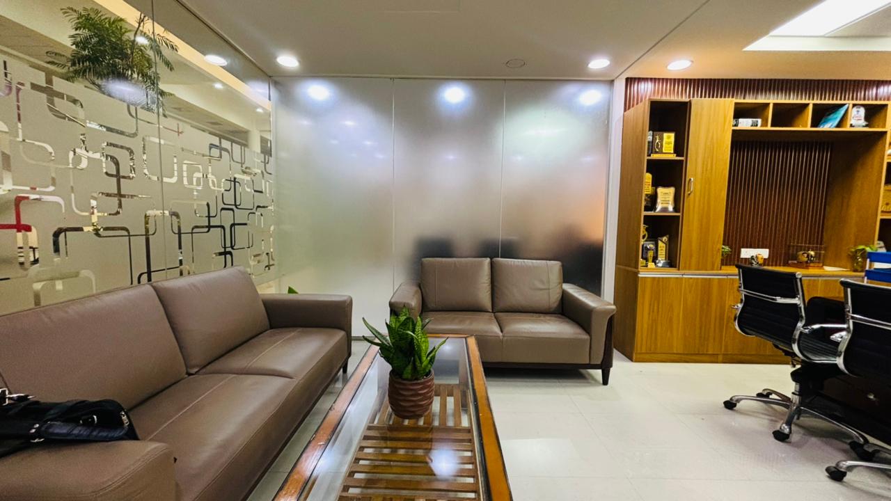 Office lounge area with leather sofas and wooden storage wall