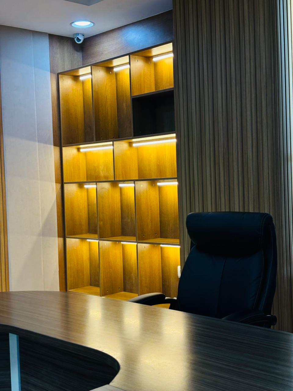 Executive desk with illuminated wooden shelving