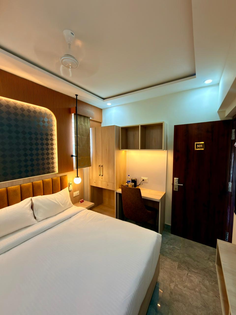 Bedroom interior with compact study unit and warm lighting