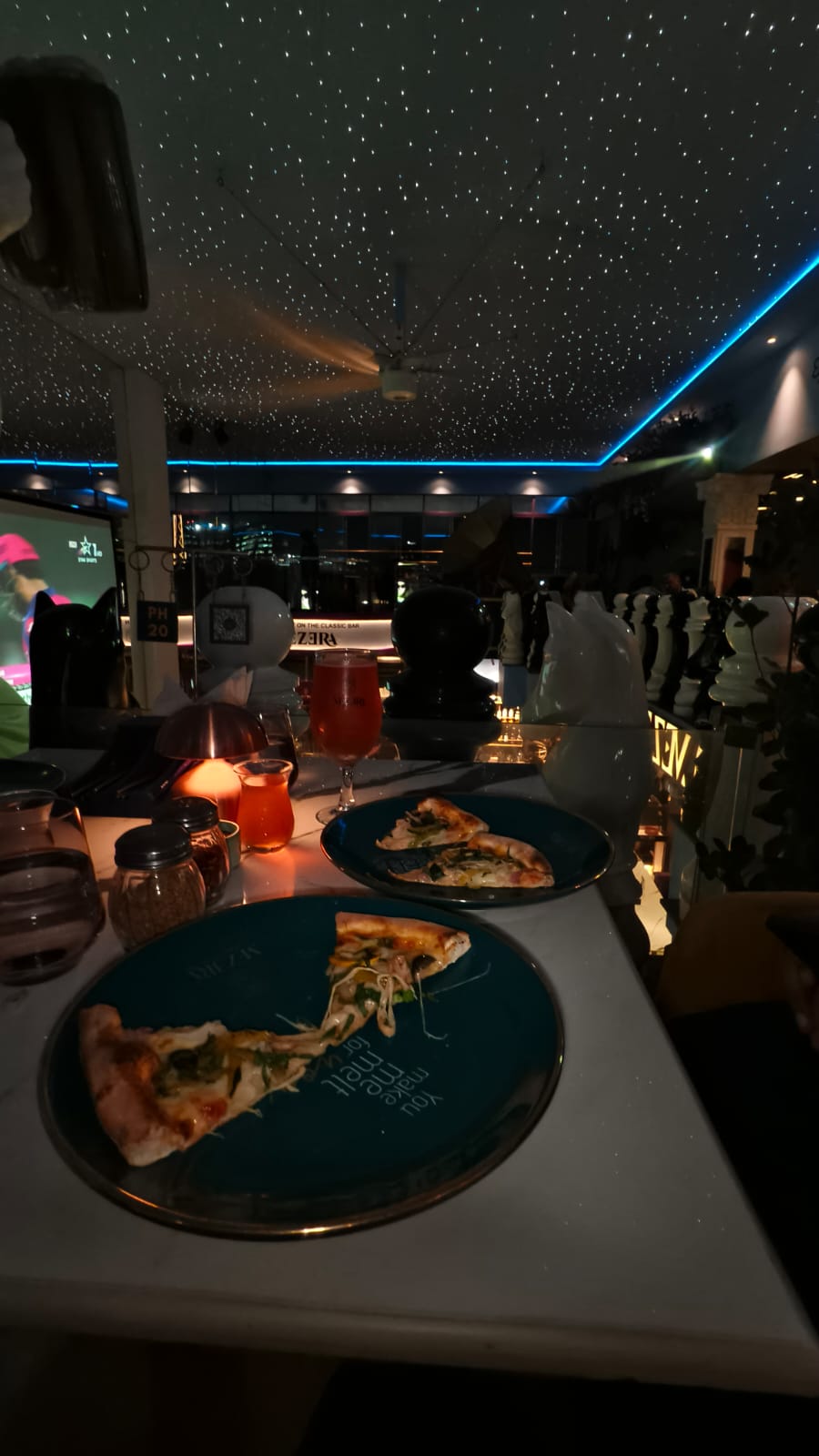 Night restaurant table setup under star ceiling lights