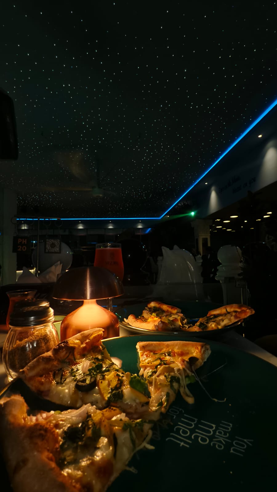 Pizza table setup with star ceiling and blue accent lighting