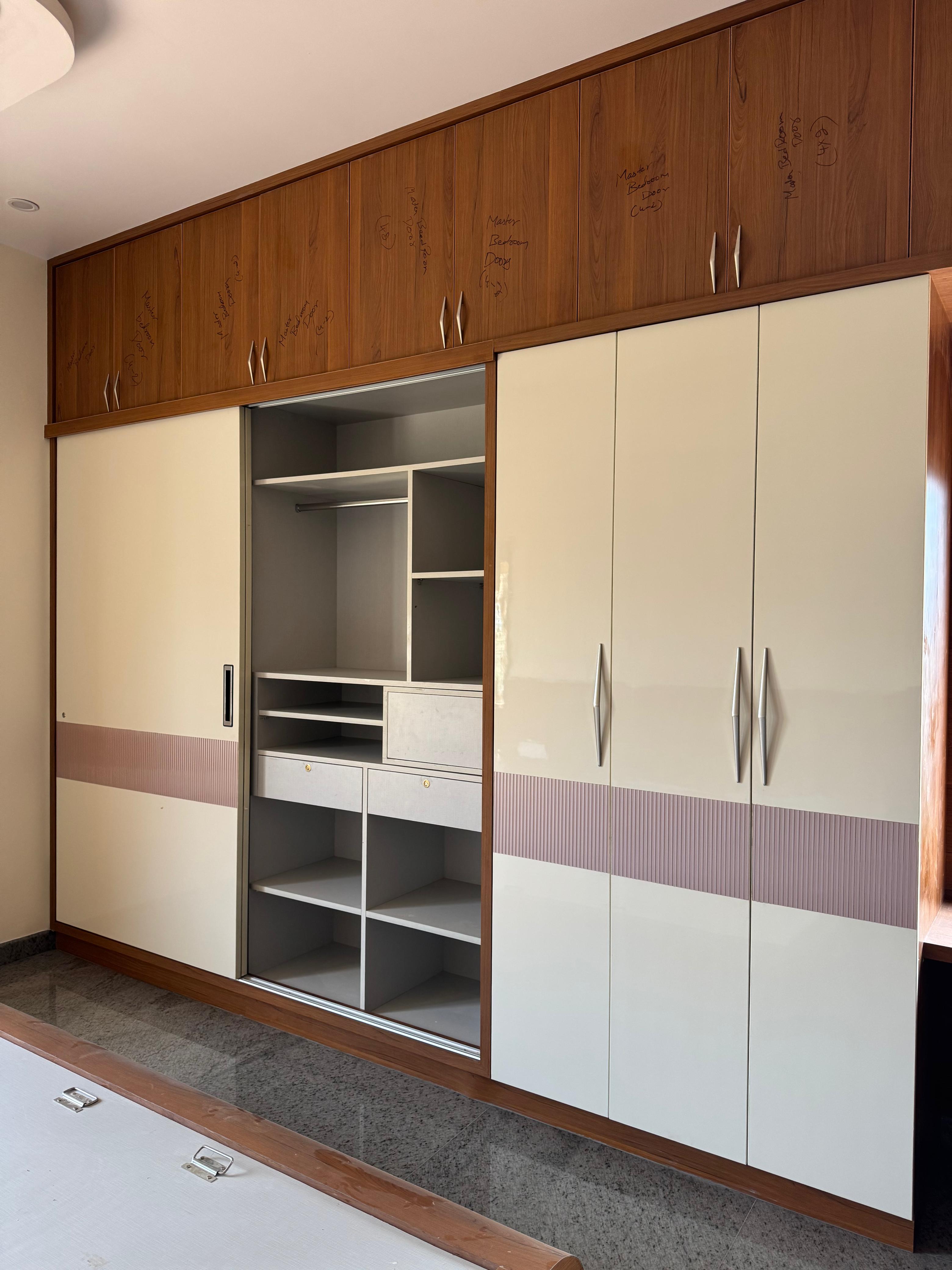 Custom bedroom wardrobe with wood and cream shutters