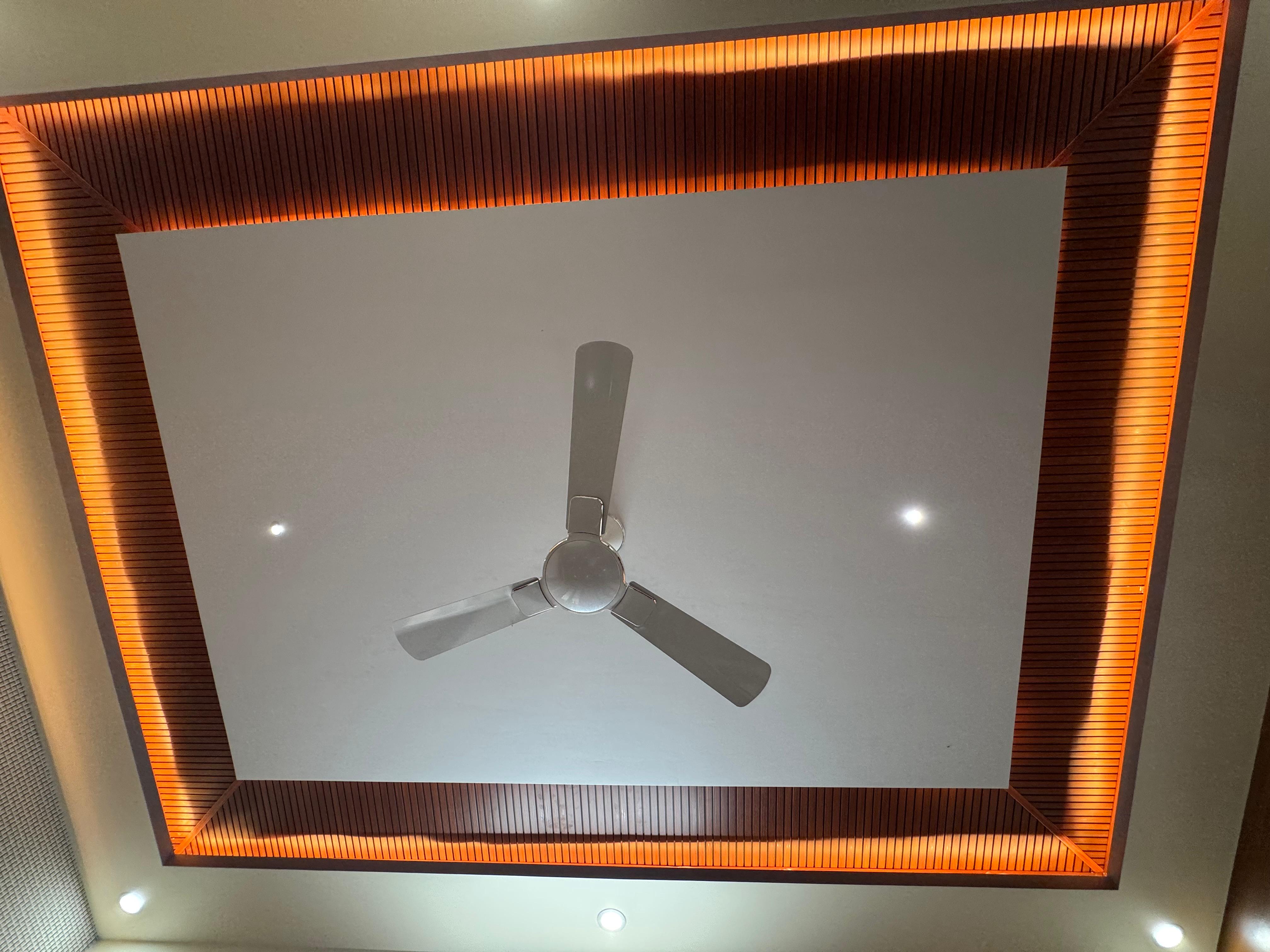 Backlit false ceiling with wood border and fan